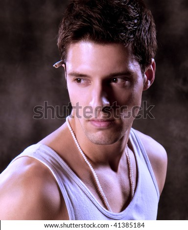 Close up  Shot of a Young Man. A trendy European man dressed in contemporary cloth. He is now a professional model.