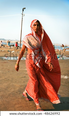 ALLAHABAD, INDIA -11 FEBRUARY: Traditionally dressed indian lady walking on Kumbh Mela the largest religious gathering on earth , February 11, 2008. Allahabad, Uttar Pradesh, India