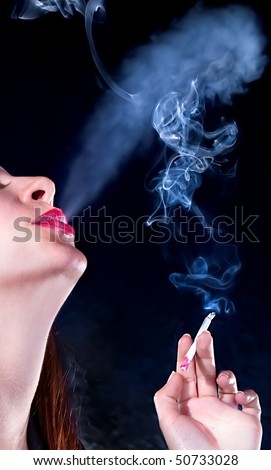 Close up business woman with cigarette .Photo-session in studio isolated on dark background