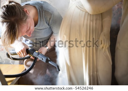 VIENNA, AUSTRIA - MAY 20: Woman restoring a marble  statue in Kunsthistorisches museum on 20 May 2010 in Vienna, Austria