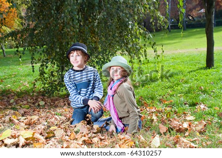 Portrait of Happy girl and boy  enjoying golden autumn fall season