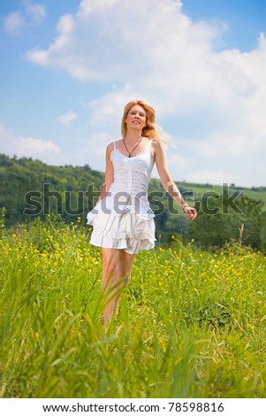 Young beautiful woman on the daisy flowers field, summer fun concept
