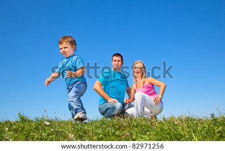 Happy family having fan in park on sunny day under the clear blue sky