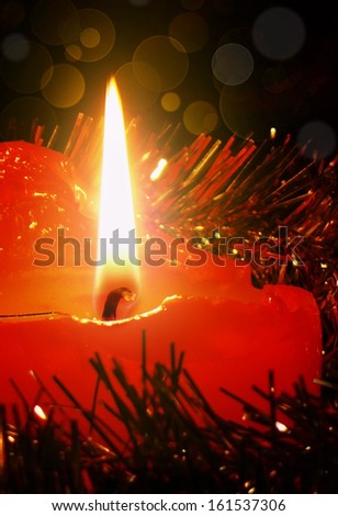 Advent candle and christmas background.