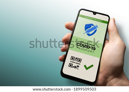 Vaccination passport for COVID-19 displayed on smartphone held in male's hand with copy space. Vaccination, disease immunity passport, health and surveillance concepts