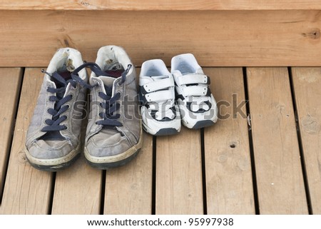 Big and small shoes on the back deck