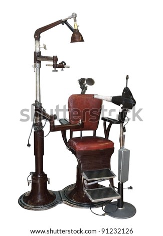 vintage dentist chair and equipment on a white background