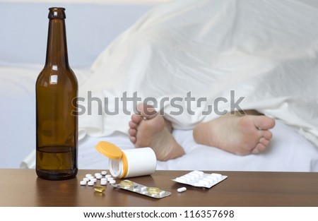 Person passed out in the bed after mixed use of alcohol and drugs.