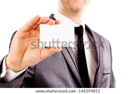 Young business man holding a blank business card over white background
