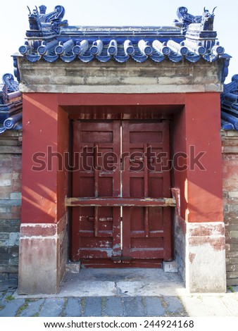 Old wooden door  in red wall. typical china architecture
