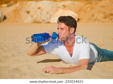 Thirsty desert traveler with face red of sun burn drinking water (side-on image)
