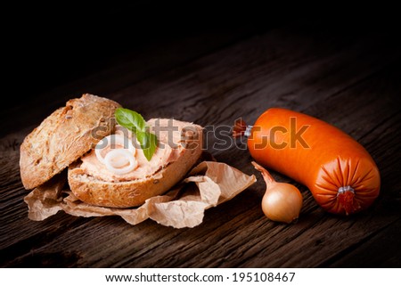 Fresh polish sandwich with meat spread. Pate composition taken on rustic wooden table.