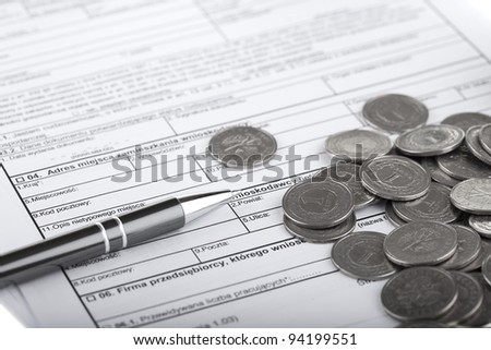 Business documents, one zloty polish coins and pen. Money and savings concept.
