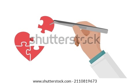 A man makes a heart puzzle with tweezers. The hand holds the puzzle piece. Foto stock © 