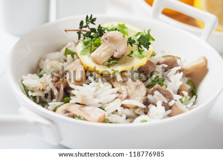 Cooked rice, risotto with herbs and button mushrooms