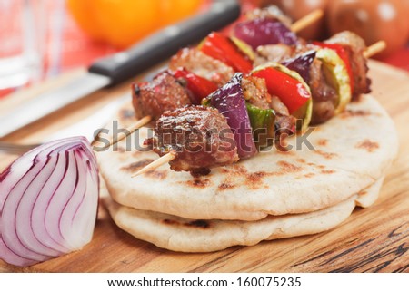 Meat and vegetable on oriental kebab skewer with pita bread