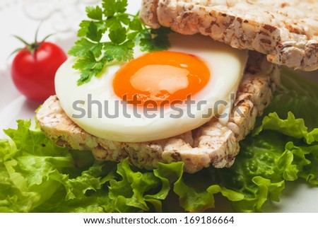 Fried egg sandwich with lettuce and rice bread