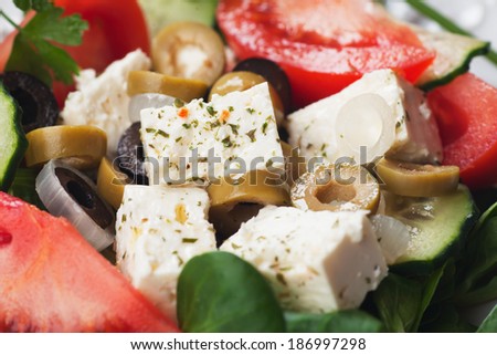 Greek salad with feta cheese, corn-salad, tomato and olives