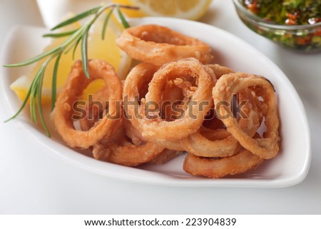 Fried squid rings served with lemon and rosemary