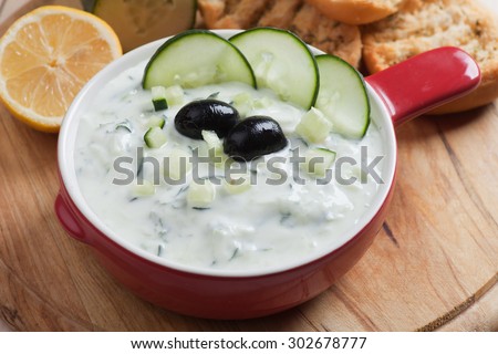 Tzatziki or cacik, cucumber and yogurt salad with black olives