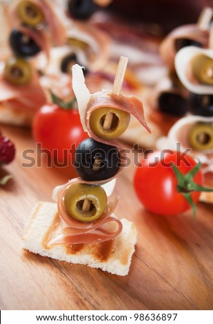 Canape with pickled olives and prosciutto di parma