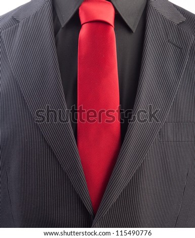 A pinstriped men\'s business suit with a red tie and black shirt.