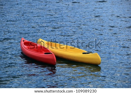 Two fiberglass kayak boat floating on water