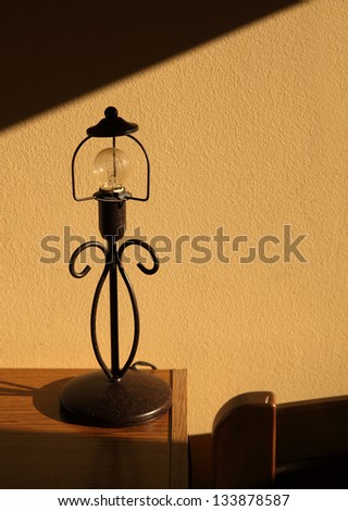 Wrought iron table lamp on bedside table