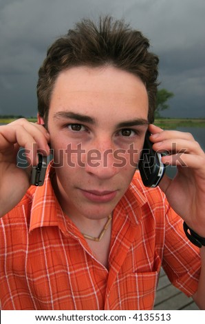 Silly guy is phoning with two phone