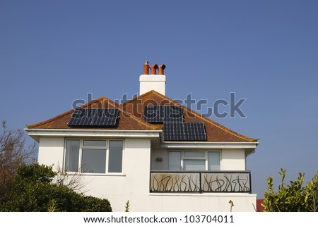 Detached house with solar panels for generating electricity on roof. Ferring. Near Worthing, West Sussex. England