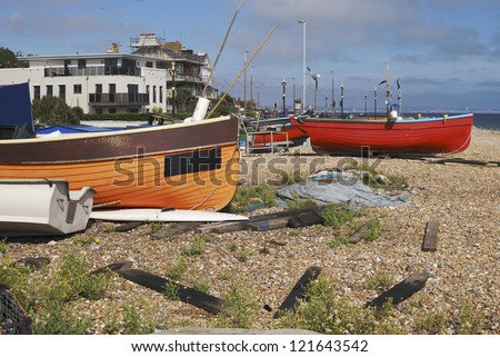 Small fishing boats on shingle beach at Worthing. West Sussex. England