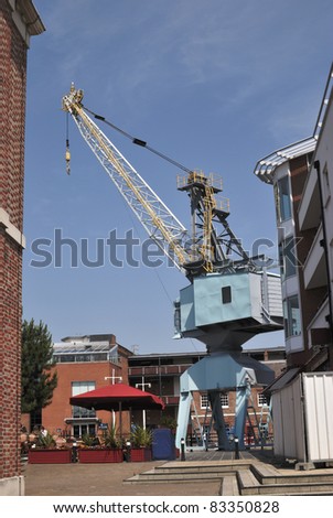 Restaurants and cafes at Gunwharf Quay in Portsmouth. Hampshire. England. With old dockside crane.