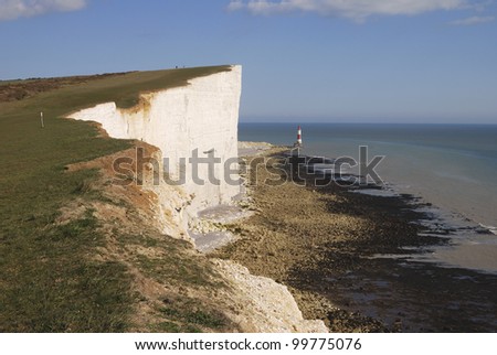 Chalk cliffs at Beachy Head near Eastbourne. East Sussex. England. With lighthouse under cliff on beach