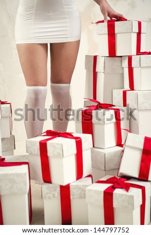 Woman\'s legs and heap of gift boxes