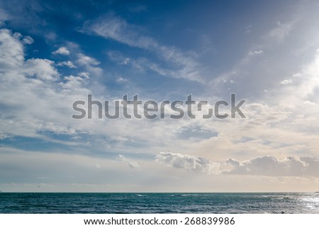 Bright cloudy sky and horizon over the sea
