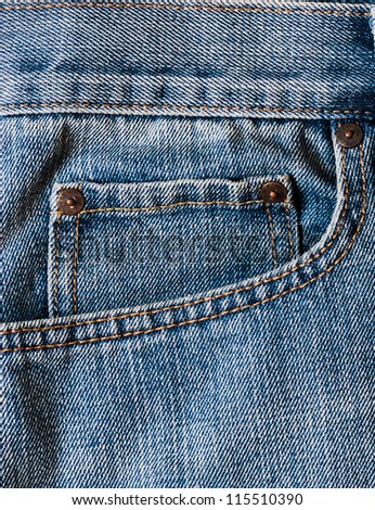 Close up up of clean washed blue jeans pockets