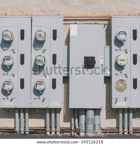 rows of electric meters in the back side of supermarket or strip mall