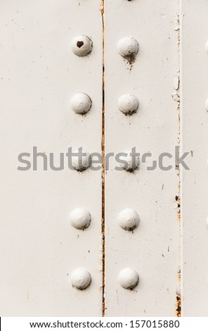 rivets on large corroding steel plates of a train and auto Bridge