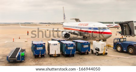 Chicago November 12: Pushback tractor driver preparing American Airline plane at O\'hare Airport , on June 10, 2013. O\'Hare International Airport resides on over 7,000 acres and is 2nd busiest airport.