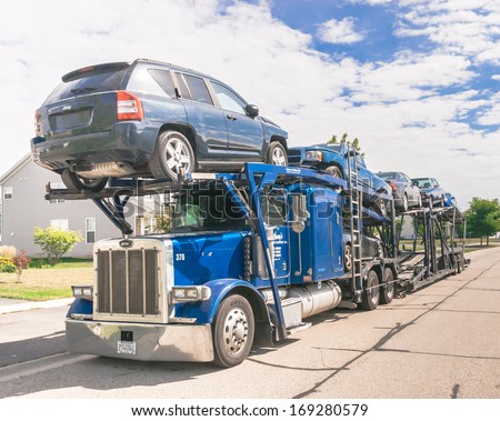 CHICAGO, ILLINOIS -  August 15: A auto carrier truck with cars loaded for transport on August 15th 2013. Moving industry has turnover of over US $12 Billion