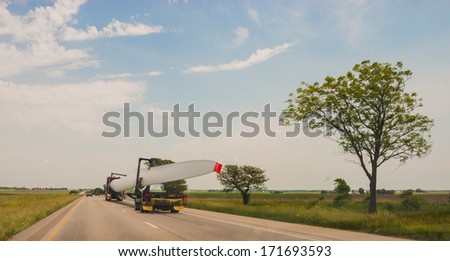 CHICAGO, IL - June 12: Oversize load of Wind Generator turbine wing on a specialized semi truck  on June 12, 2013.