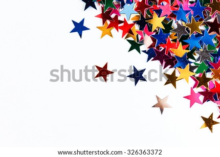 Star-shaped confetti on white background close-up