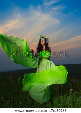 Portrait of a beautiful young woman on background of sunset. Mystic pictures.