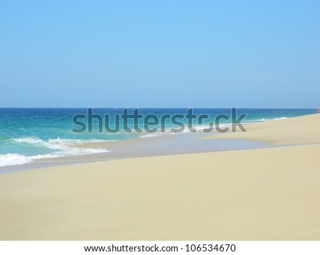 White sandy beach, turquoise ocean and waves