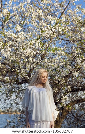 woman looking down at a white tree
