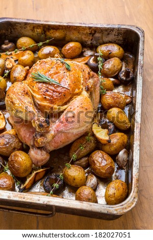 Whole Roasted Chicken with New Potatoes, Mushrooms, Lemon Wedges and Garlic Cloves