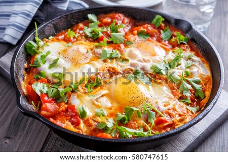 Similar – Image, Stock Photo Fried eggs with tomatoes and broccoli in white frying pan on kitchen table with ingredients. Top view. Healthy breakfast