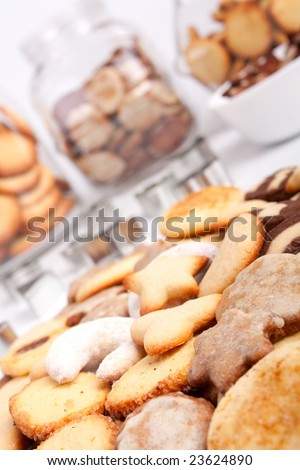 Big Pile of Different Cookies with Three Cookie Jars in the Background