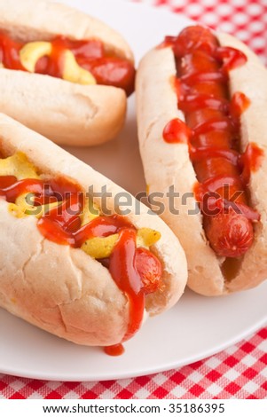 group of hot dogs on checked table-cloth table