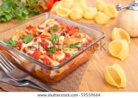 Stuffed Shell Pasta with Tomato Sauce and Cheese Baked in a Casserole Dish and Ingredients